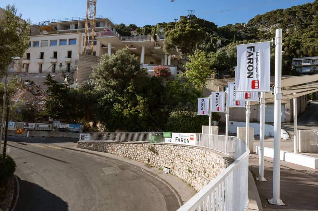 View of Mont Faron cable car station in Toulon, showcasing the structure and surrounding greenery.
