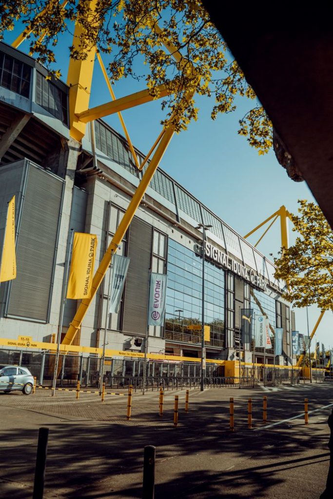 Exterior view of Signal Iduna Park Stadium in Dortmund, showcasing modern architecture under a clear sky.